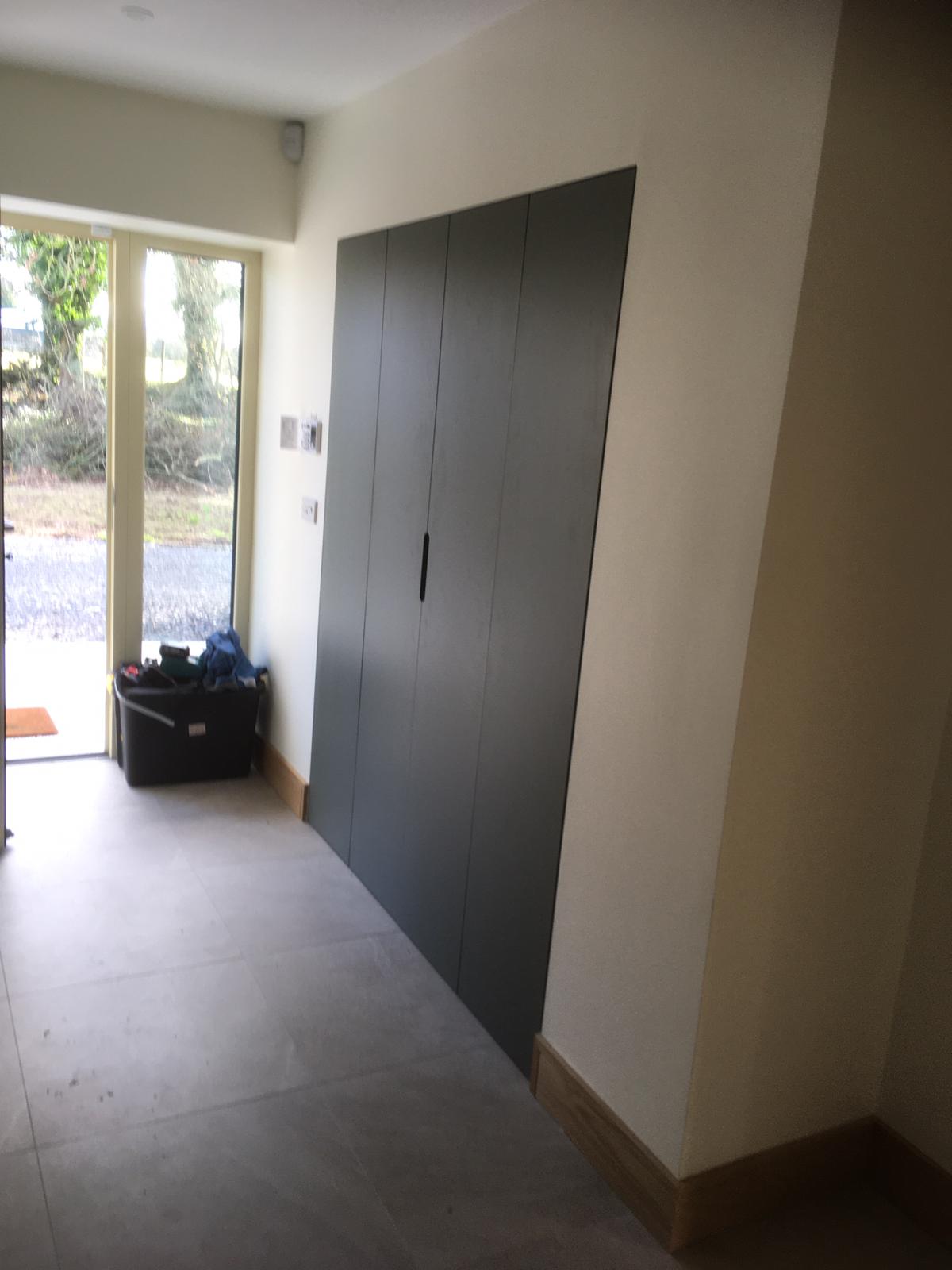 Sage fitted entry wardrobe viewed from the hallway.